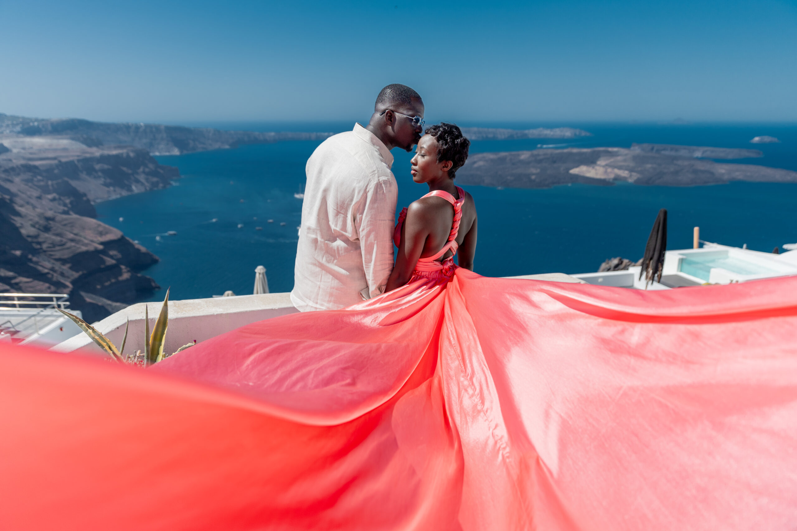 Santorini love story photoshoot. Santorini Photographer. Santorini. Santorini Photoshoot. Flying Dress Photoshoot in Santorini. Santorini Photography. Proposal Santorini