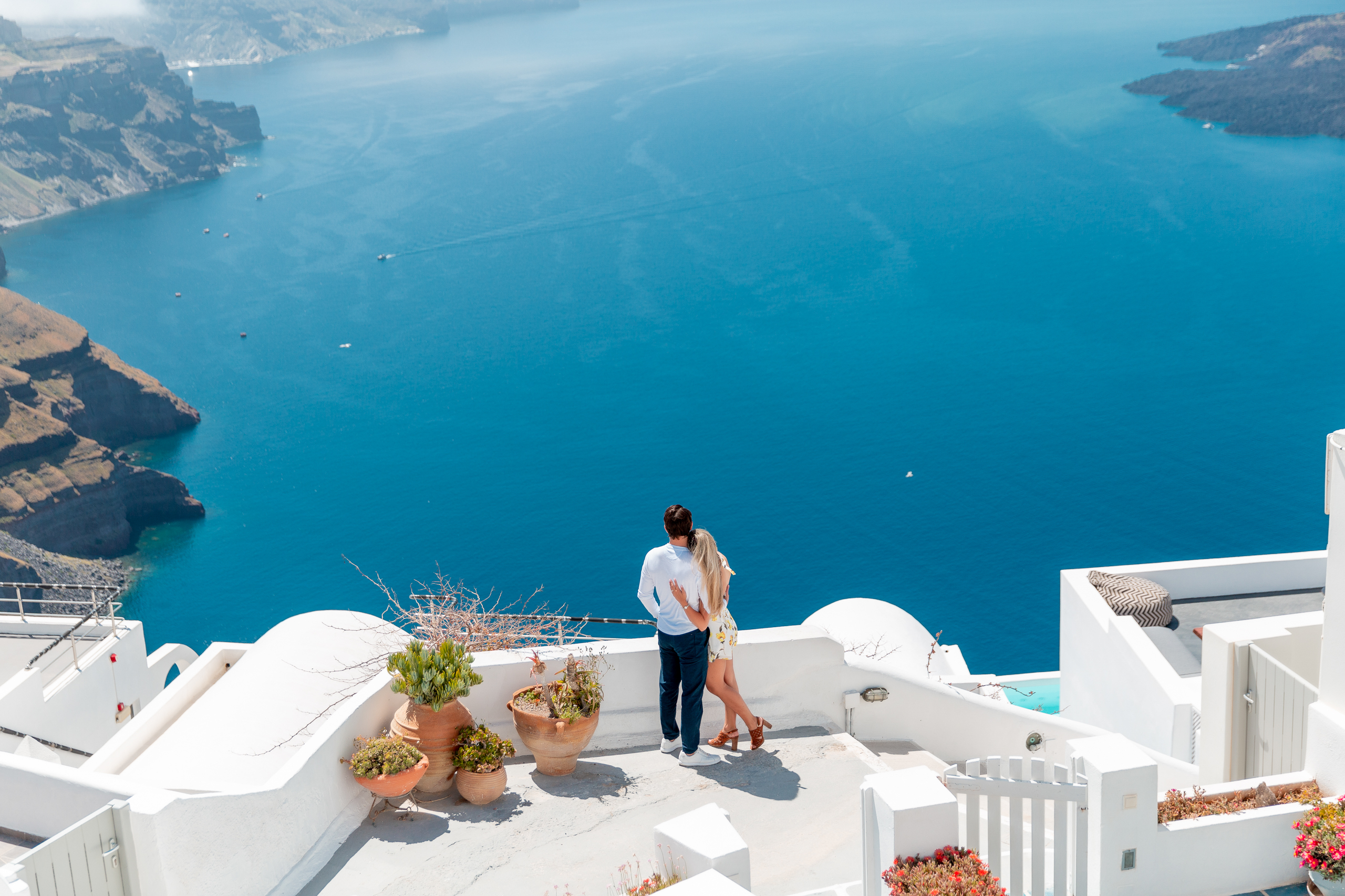 Santorini love story photoshoot. Santorini Photographer. Santorini. Santorini Photoshoot. Flying Dress Photoshoot in Santorini. Santorini Photography. Proposal Santorini