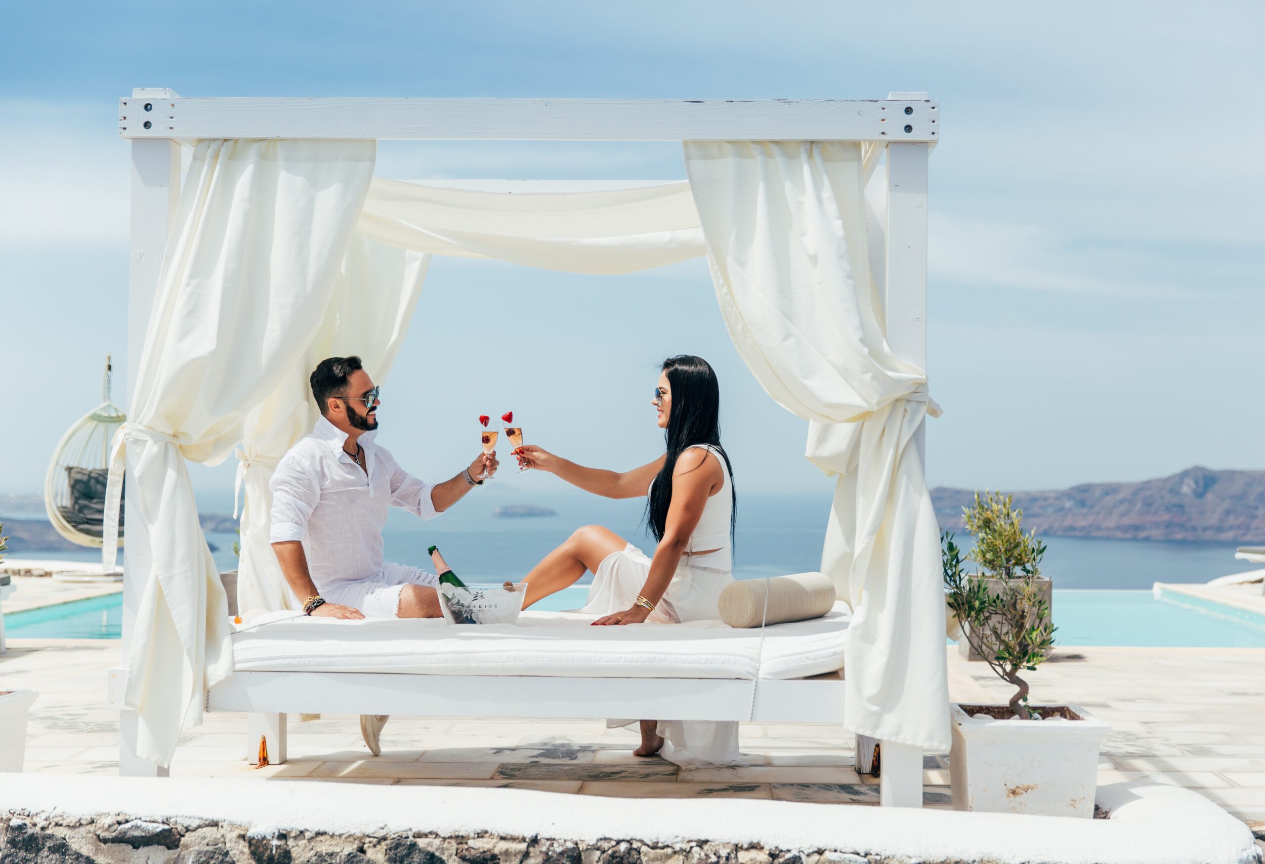 Santorini Photographer. Santorini photo shoot with flying dress. Santorini Photoshoot. Flying Dress Photoshoot in Santorini. Santorini Photography. Group Santorini photoshoot