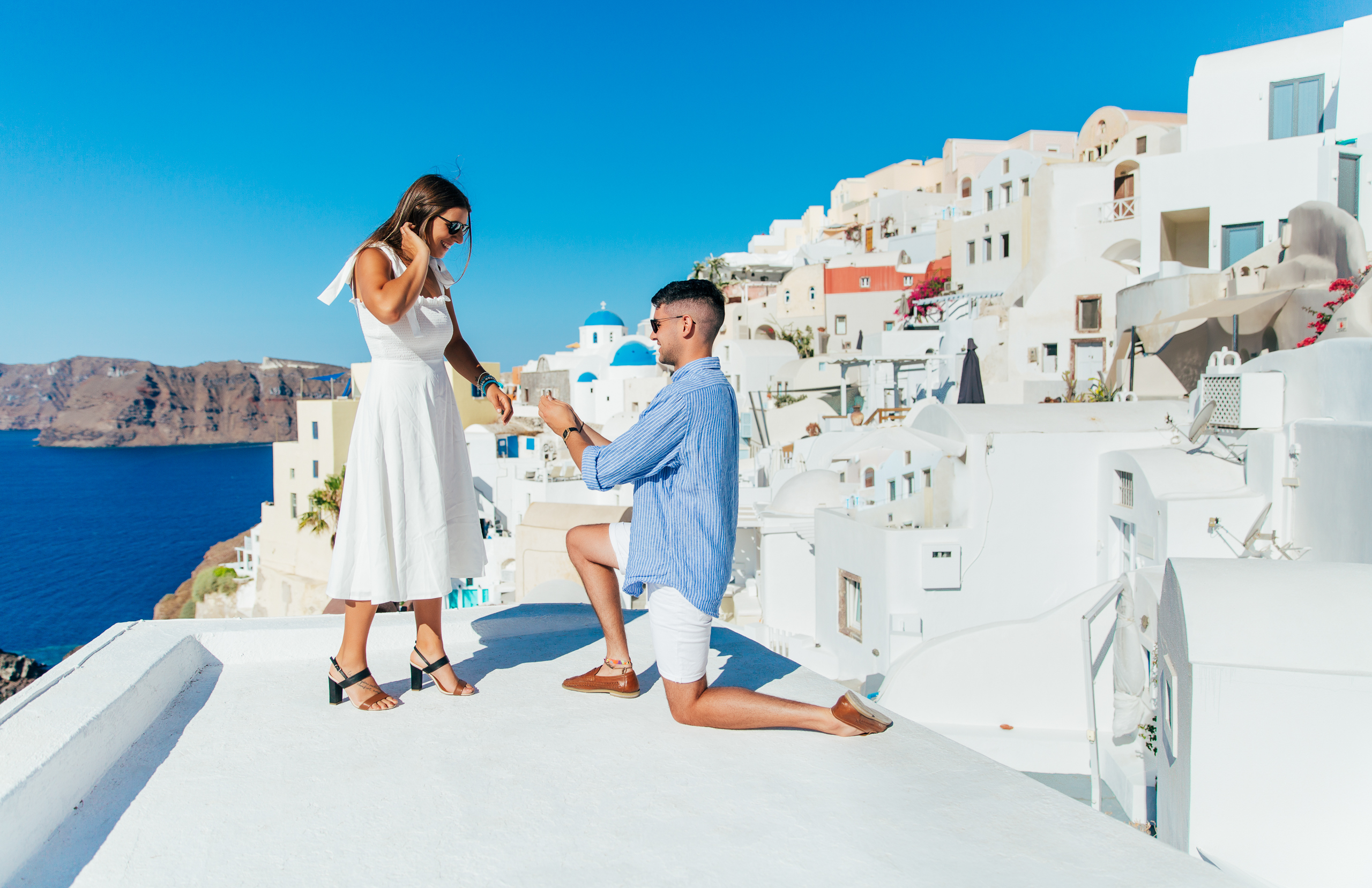 Proposal Santorini. Santorini love story photoshoot. Santorini Photographer. Santorini. Santorini Photoshoot. Flying Dress Photoshoot in Santorini. Santorini Photography.
