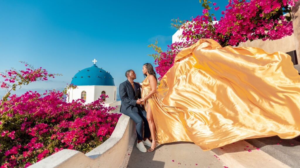 Santorini love story photoshoot. Santorini Photographer. Santorini. Santorini Photoshoot. Flying Dress Photoshoot in Santorini. Santorini Photography. Proposal Santorini