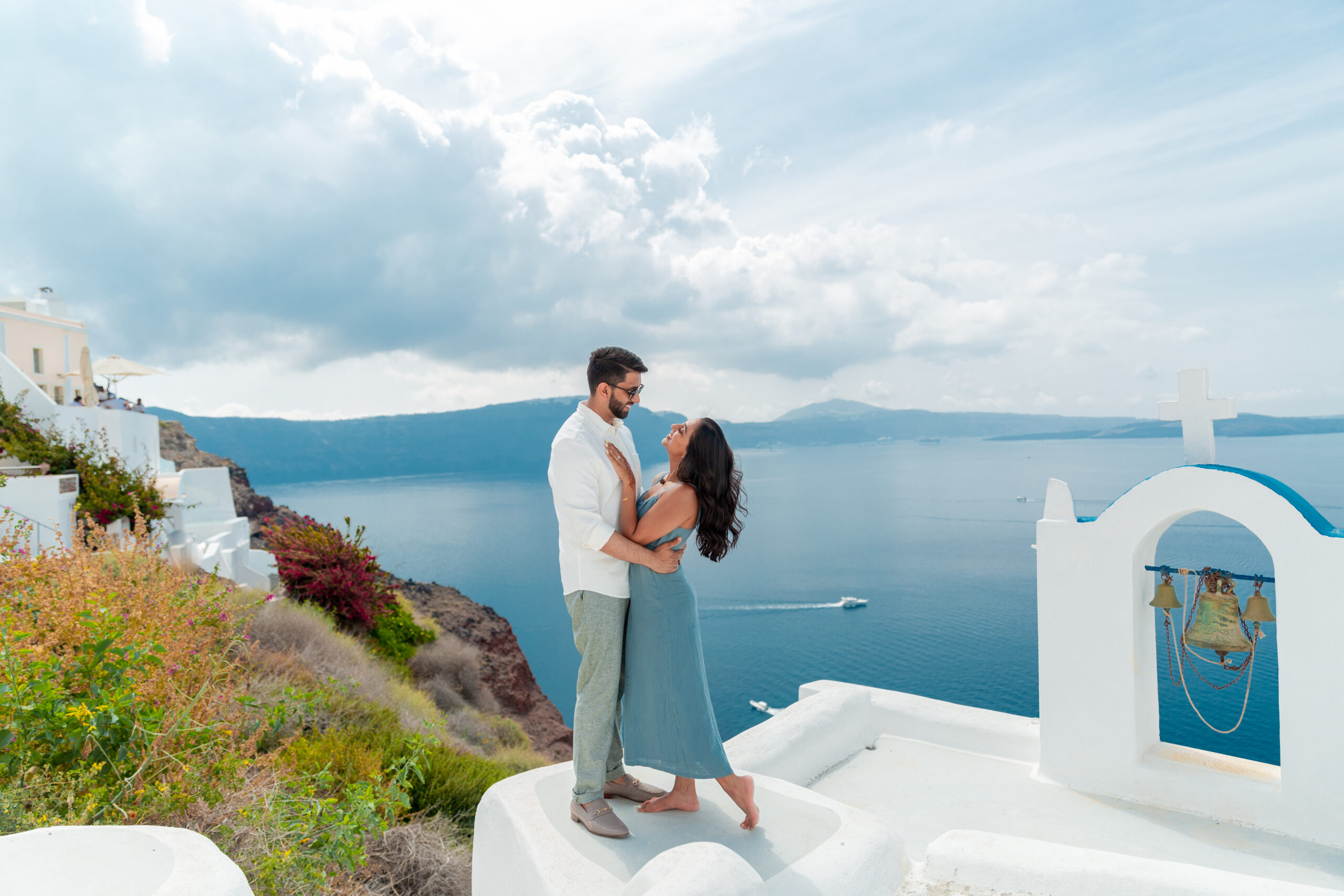 Santorini love story photoshoot. Santorini Photographer. Santorini. Santorini Photoshoot. Flying Dress Photoshoot in Santorini. Santorini Photography. Proposal Santorini