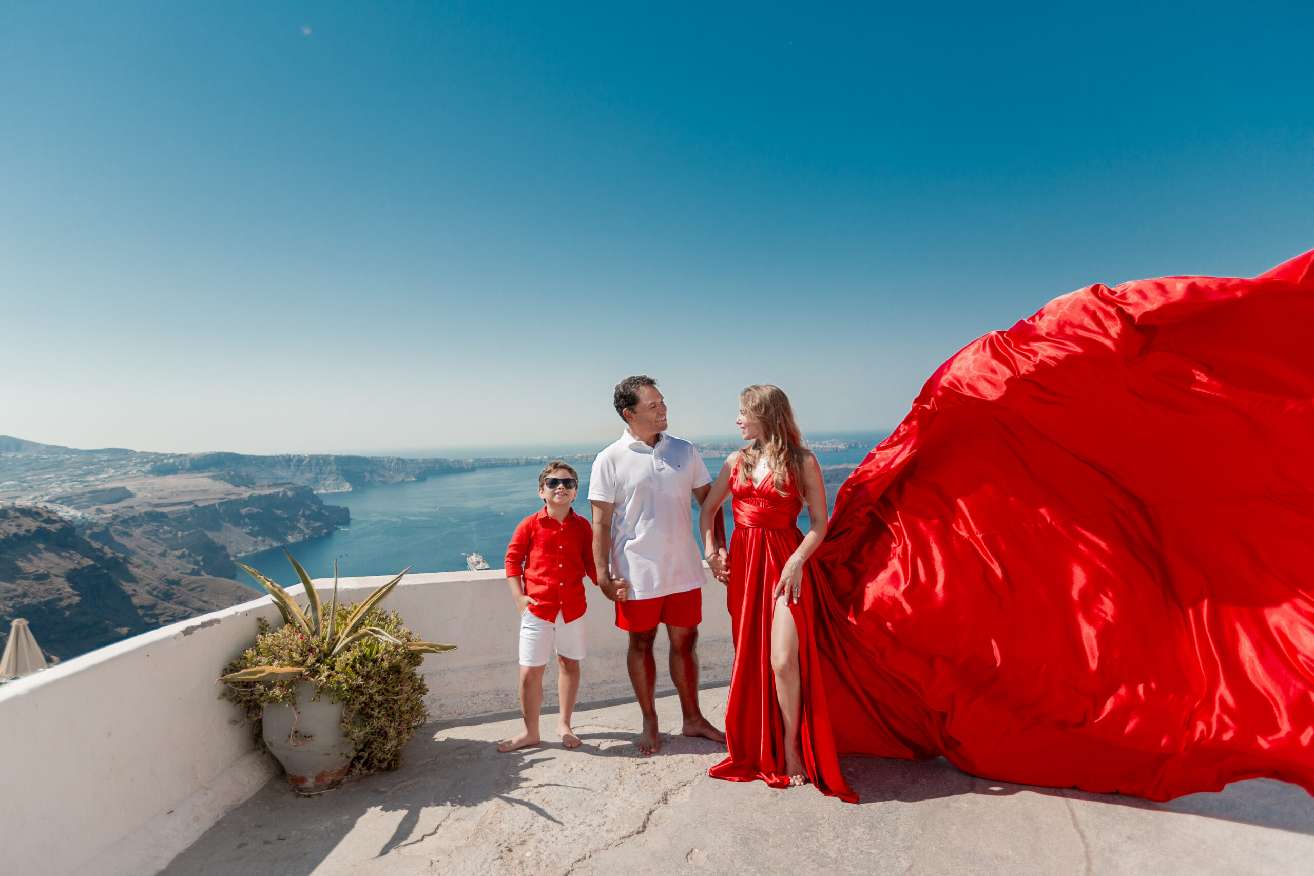 Family photoshoot in Santorini. Santorini Photographer. Santorini. Santorini Photoshoot. Flying Dress Photoshoot in Santorini. Santorini Photography.