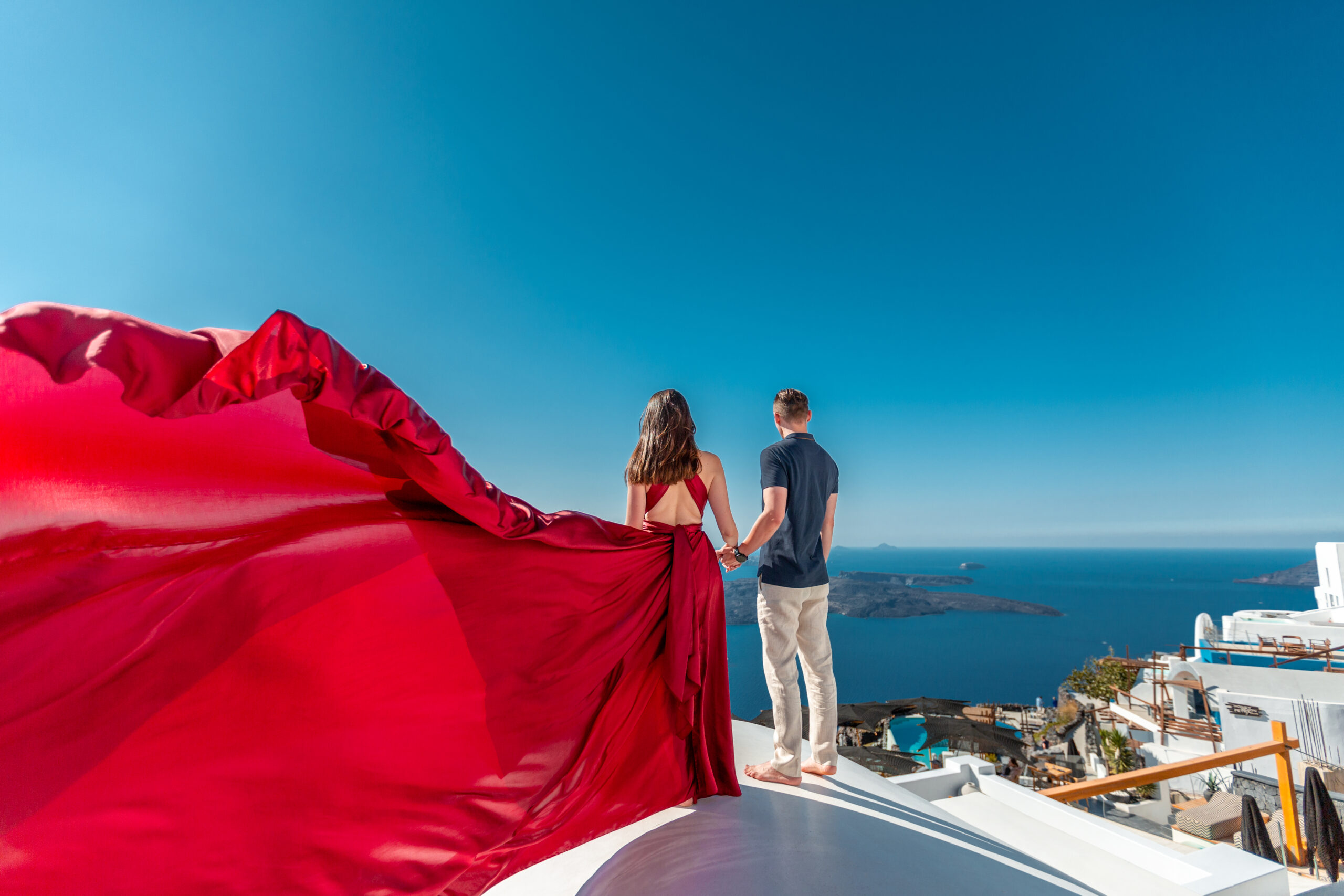 Santorini love story photoshoot. Santorini Photographer. Santorini. Santorini Photoshoot. Flying Dress Photoshoot in Santorini. Santorini Photography. Proposal Santorini