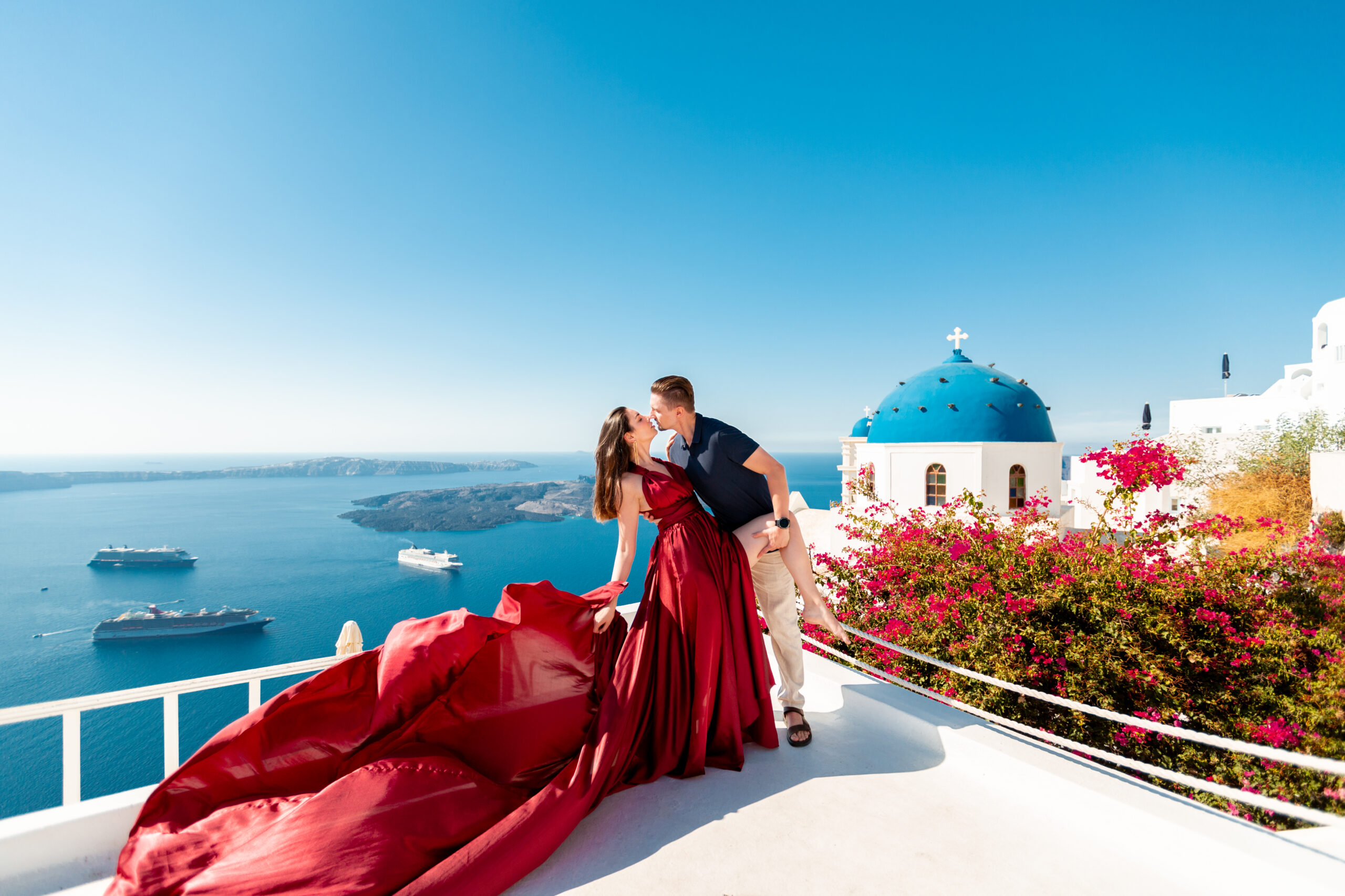 Santorini love story photoshoot. Santorini Photographer. Santorini. Santorini Photoshoot. Flying Dress Photoshoot in Santorini. Santorini Photography. Proposal Santorini