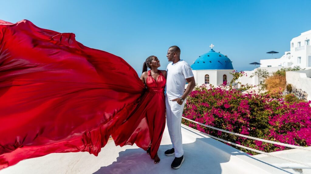 Santorini love story photoshoot. Santorini Photographer. Santorini. Santorini Photoshoot. Flying Dress Photoshoot in Santorini. Santorini Photography. Proposal Santorini