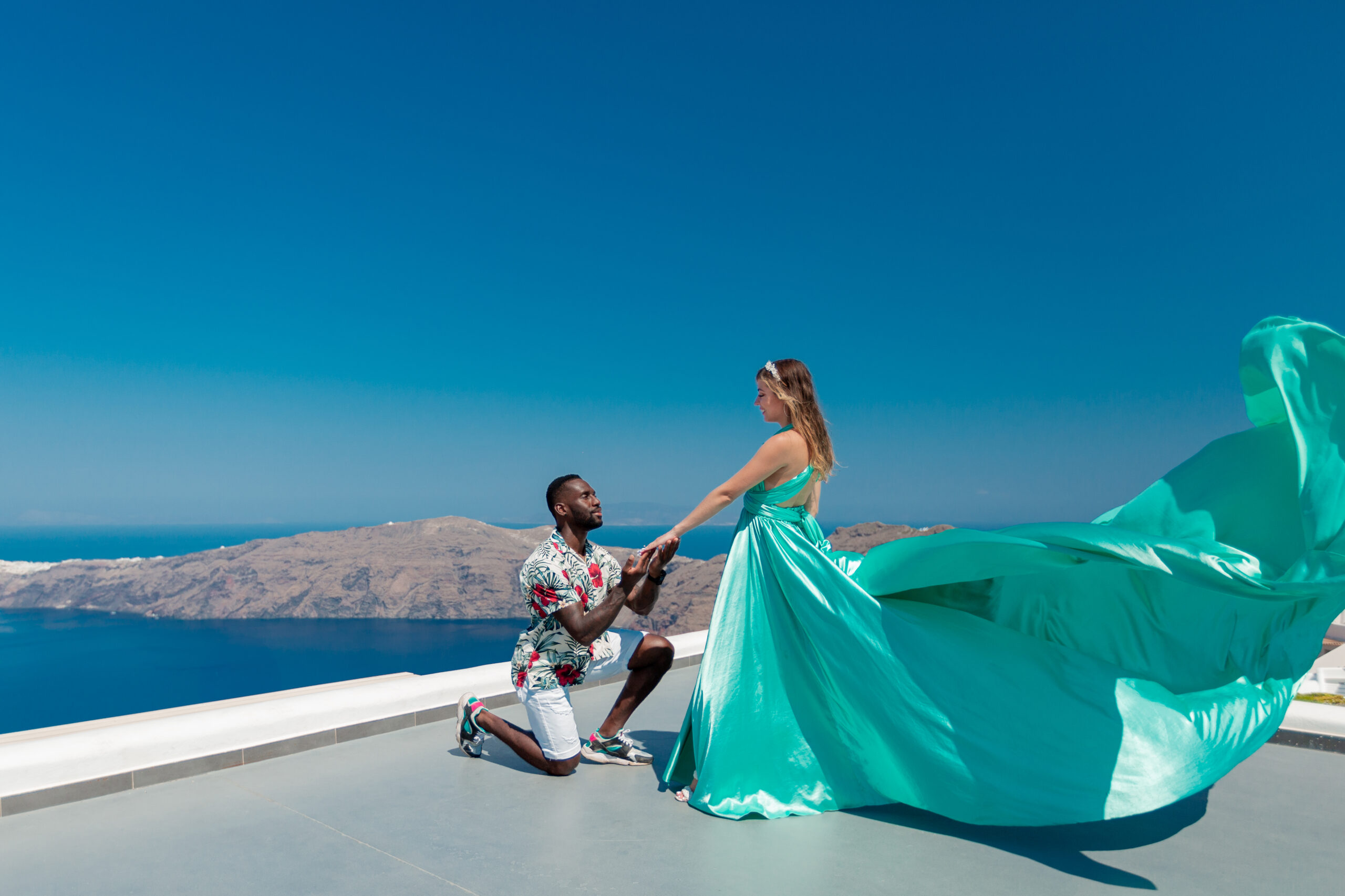 Proposal Santorini. Santorini love story photoshoot. Santorini Photographer. Santorini. Santorini Photoshoot. Flying Dress Photoshoot in Santorini. Santorini Photography.
