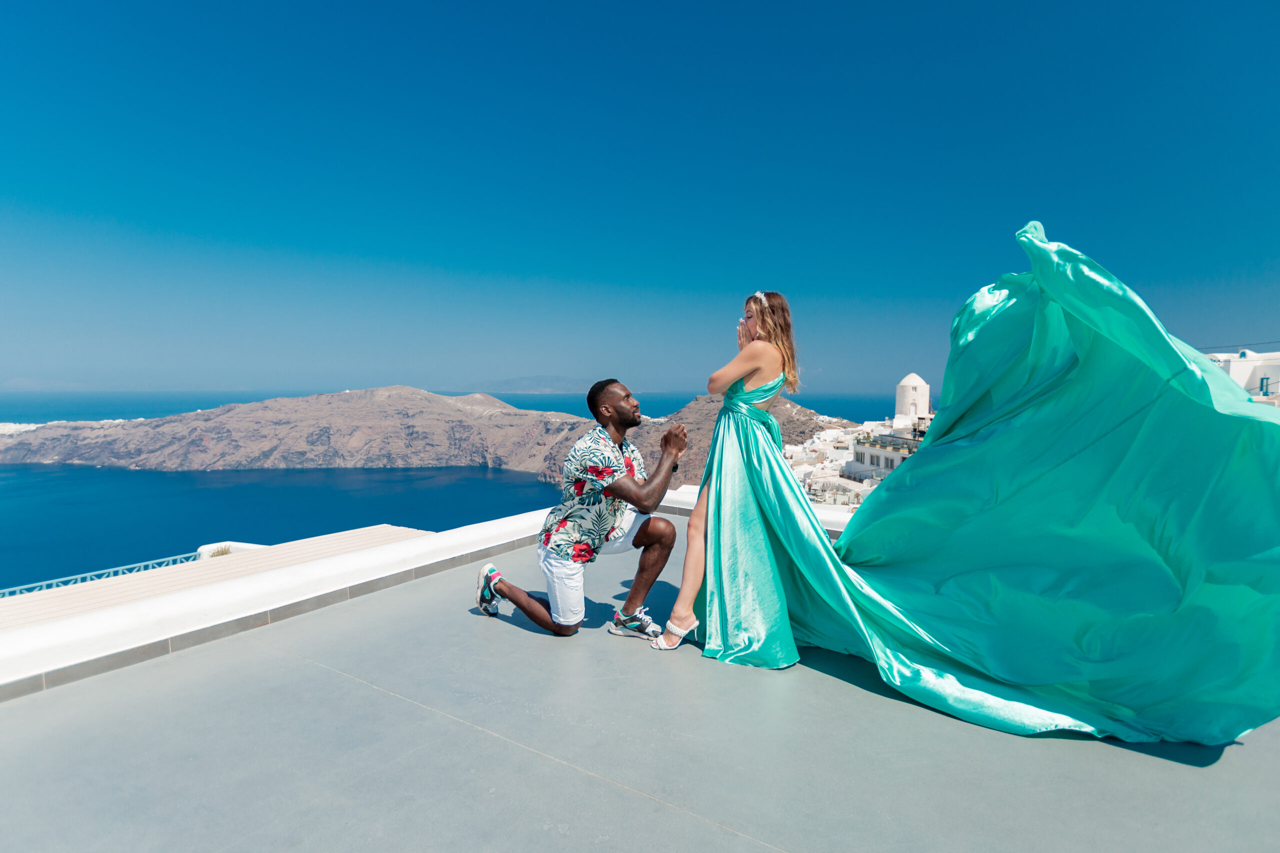 Proposal Santorini. Santorini love story photoshoot. Santorini Photographer. Santorini. Santorini Photoshoot. Flying Dress Photoshoot in Santorini. Santorini Photography.