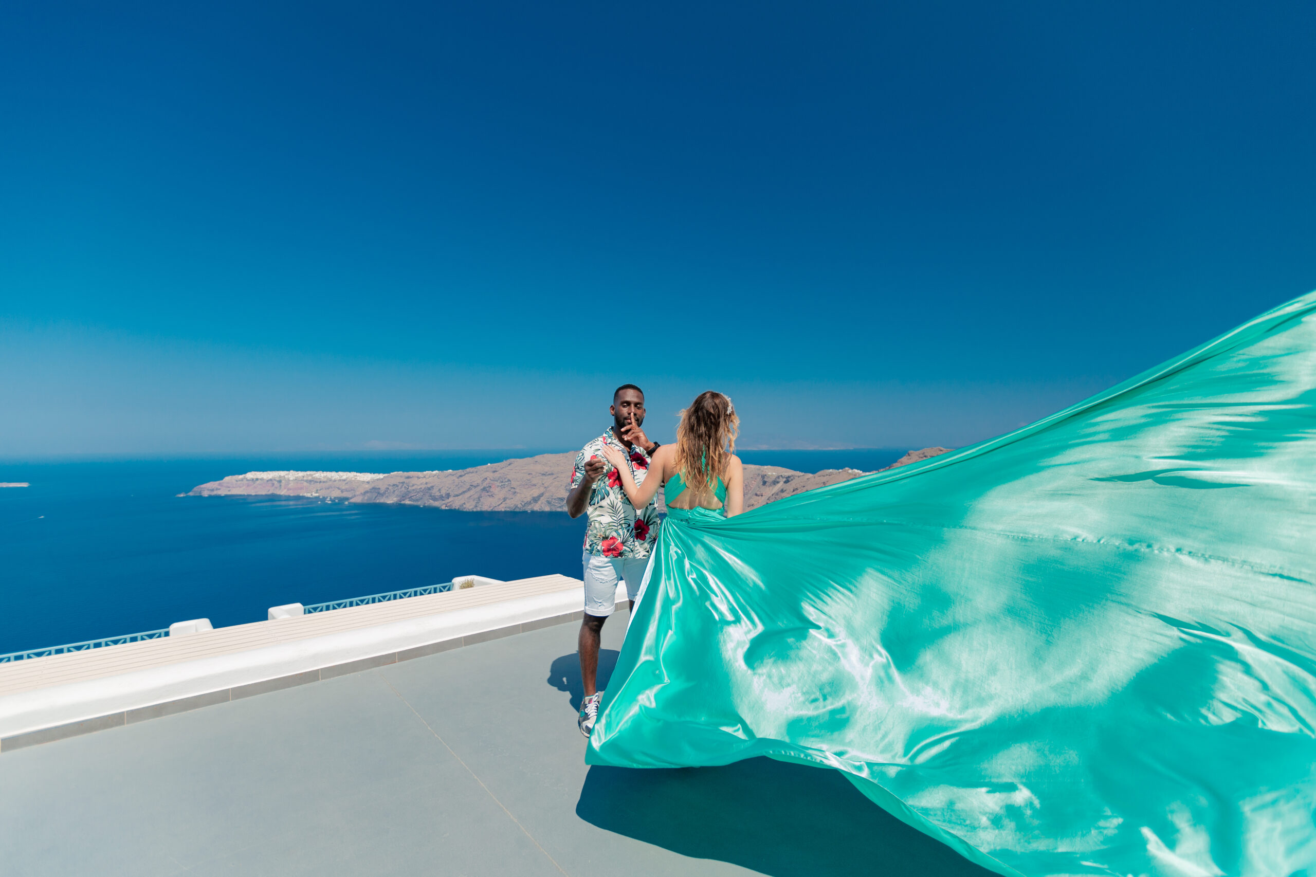 Proposal Santorini. Santorini love story photoshoot. Santorini Photographer. Santorini. Santorini Photoshoot. Flying Dress Photoshoot in Santorini. Santorini Photography.