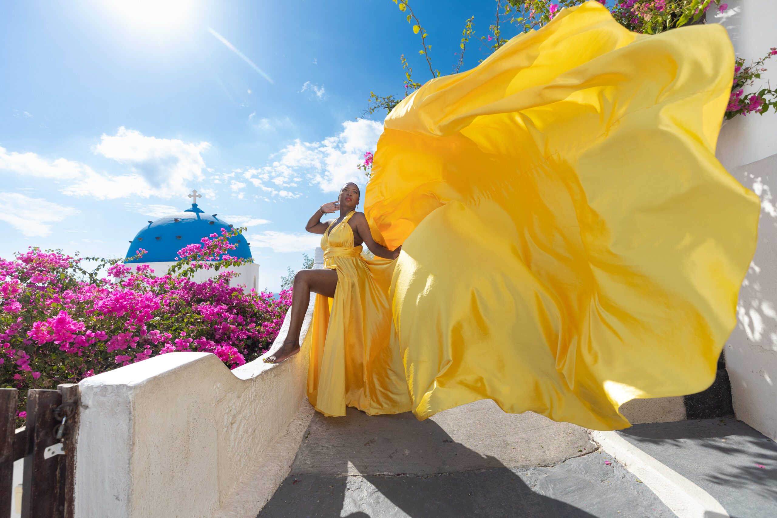 Santorini Photographer. Santorini photo shoot with flying dress. Santorini Photoshoot. Flying Dress Photoshoot in Santorini. Santorini Photography. Group Santorini photoshoot