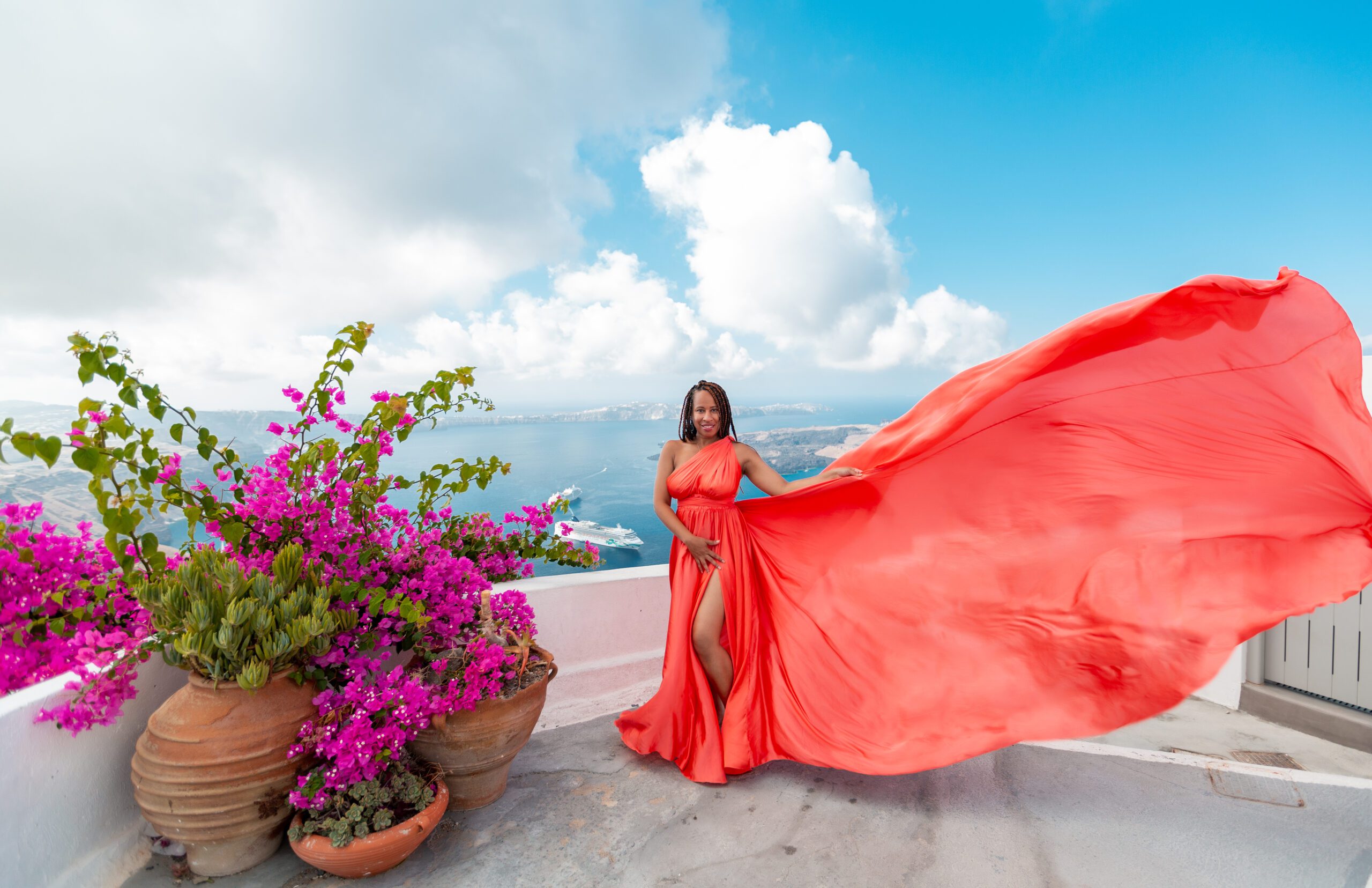 Watermelon pink dress for a vibrant Santorini photo session with soft movement and romantic color.