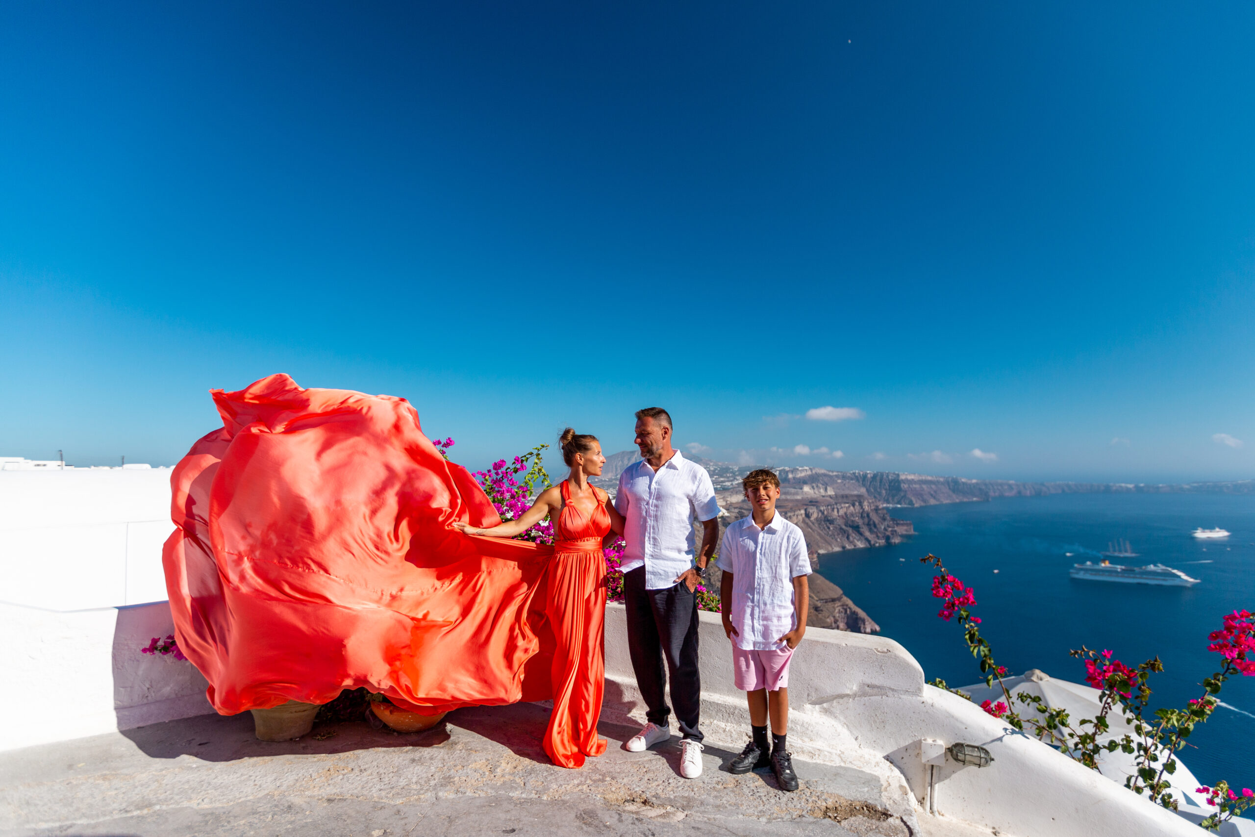 Family photoshoot in Santorini. Santorini Photographer. Santorini. Santorini Photoshoot. Flying Dress Photoshoot in Santorini. Santorini Photography.