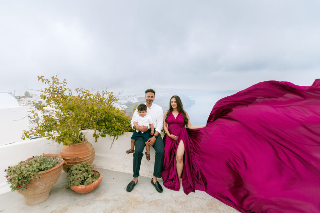 Santorini Photographer. Santorini photo shoot with flying dress. Santorini Photoshoot. Flying Dress Photoshoot in Santorini. Santorini Photography. Group Santorini photoshoot