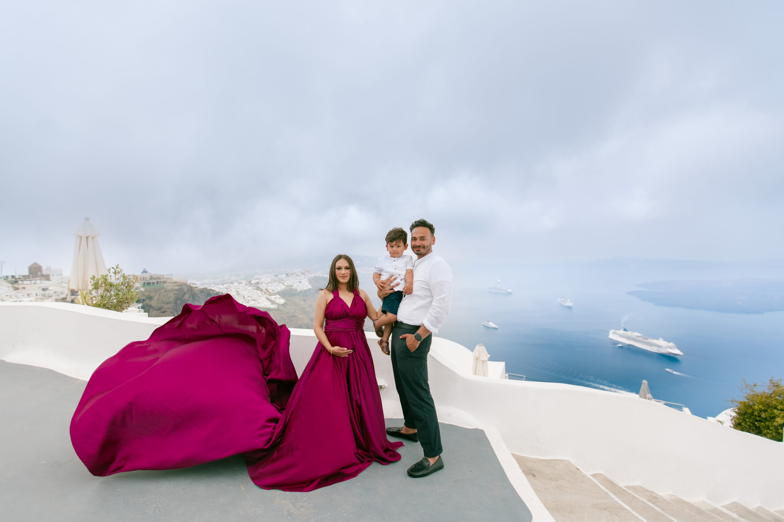 Family photoshoot in Santorini. Santorini Photographer. Santorini. Santorini Photoshoot. Flying Dress Photoshoot in Santorini. Santorini Photography.
