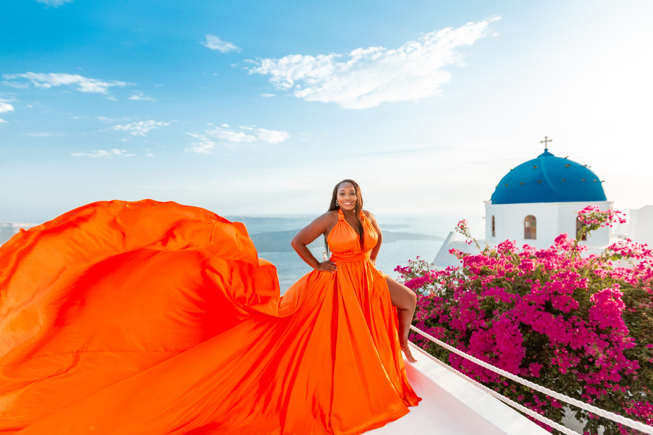Santorini Photographer. Santorini photo shoot with flying dress. Santorini Photoshoot. Flying Dress Photoshoot in Santorini. Santorini Photography. Group Santorini photoshoot