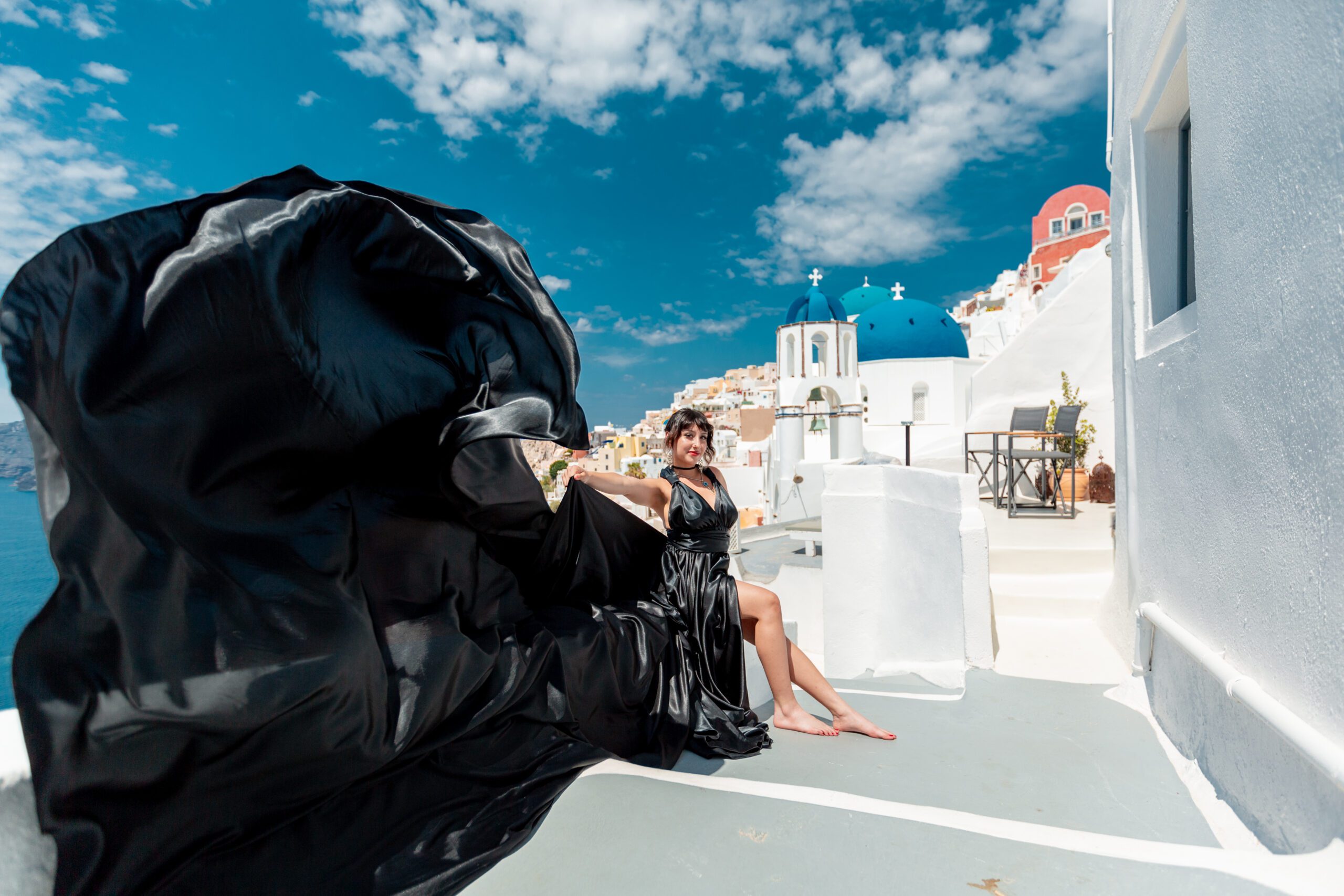 Santorini Photographer. Santorini photo shoot with flying dress. Santorini Photoshoot. Flying Dress Photoshoot in Santorini. Santorini Photography. Group Santorini Photoshoot