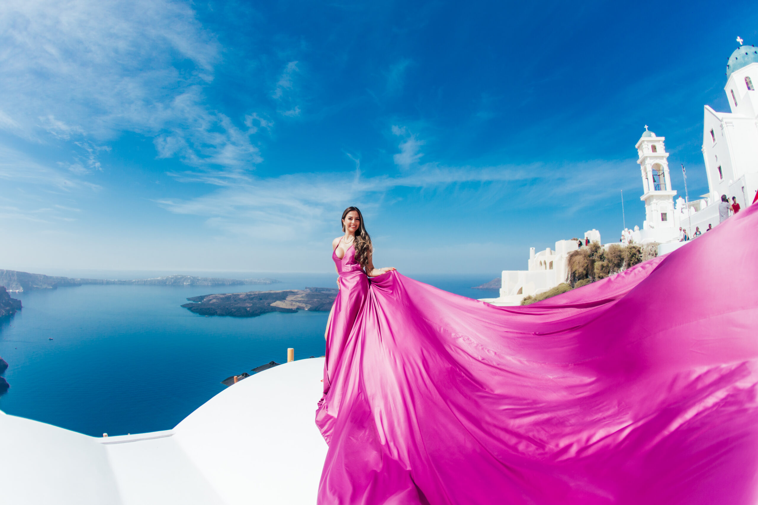 Santorini Photographer. Santorini photo shoot with flying dress. Santorini Photoshoot. Flying Dress Photoshoot in Santorini. Santorini Photography. Group Santorini photoshoot