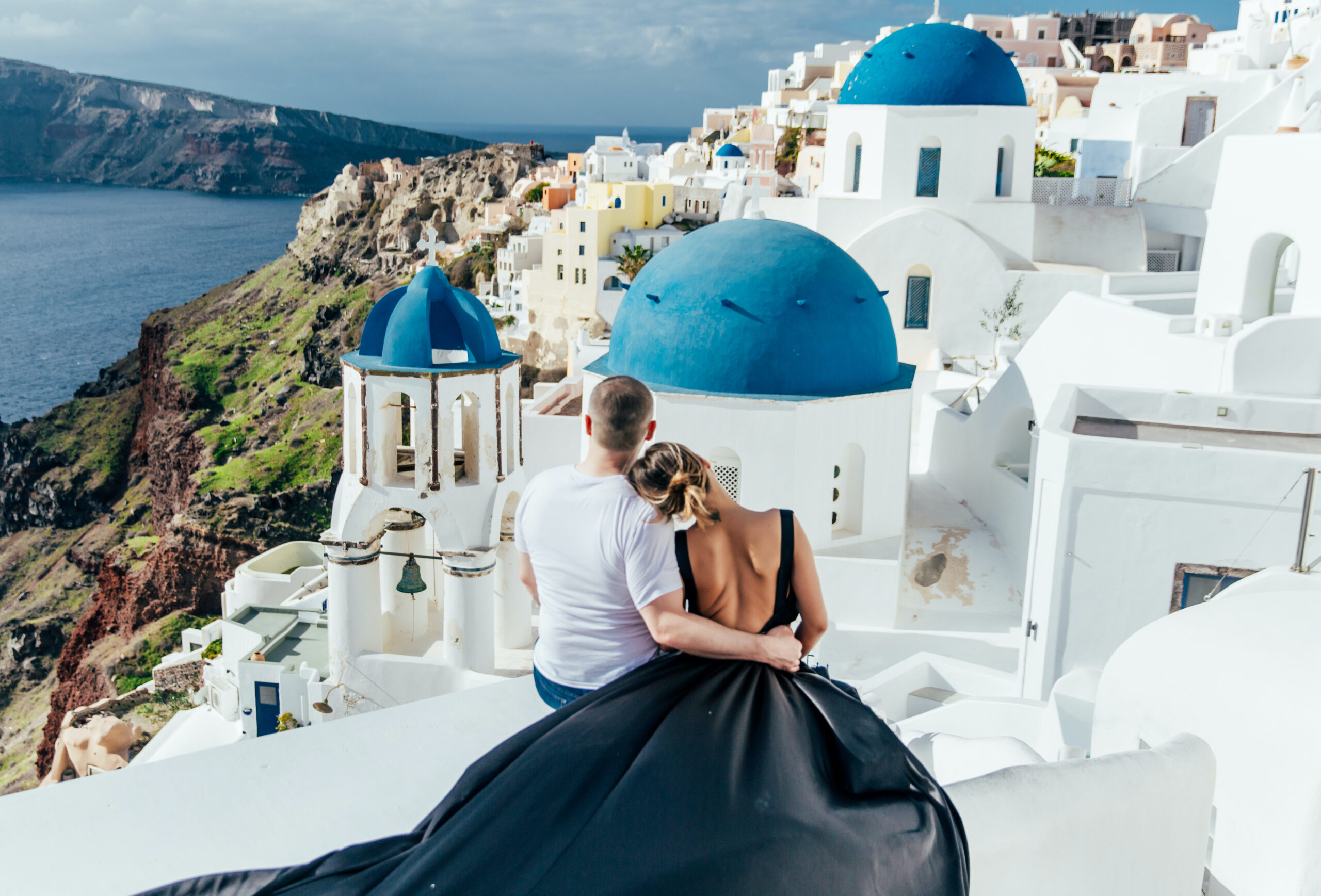 Santorini Photographer. Santorini photo shoot with flying dress. Santorini Photoshoot. Flying Dress Photoshoot in Santorini. Santorini Photography. Group Santorini photoshoot