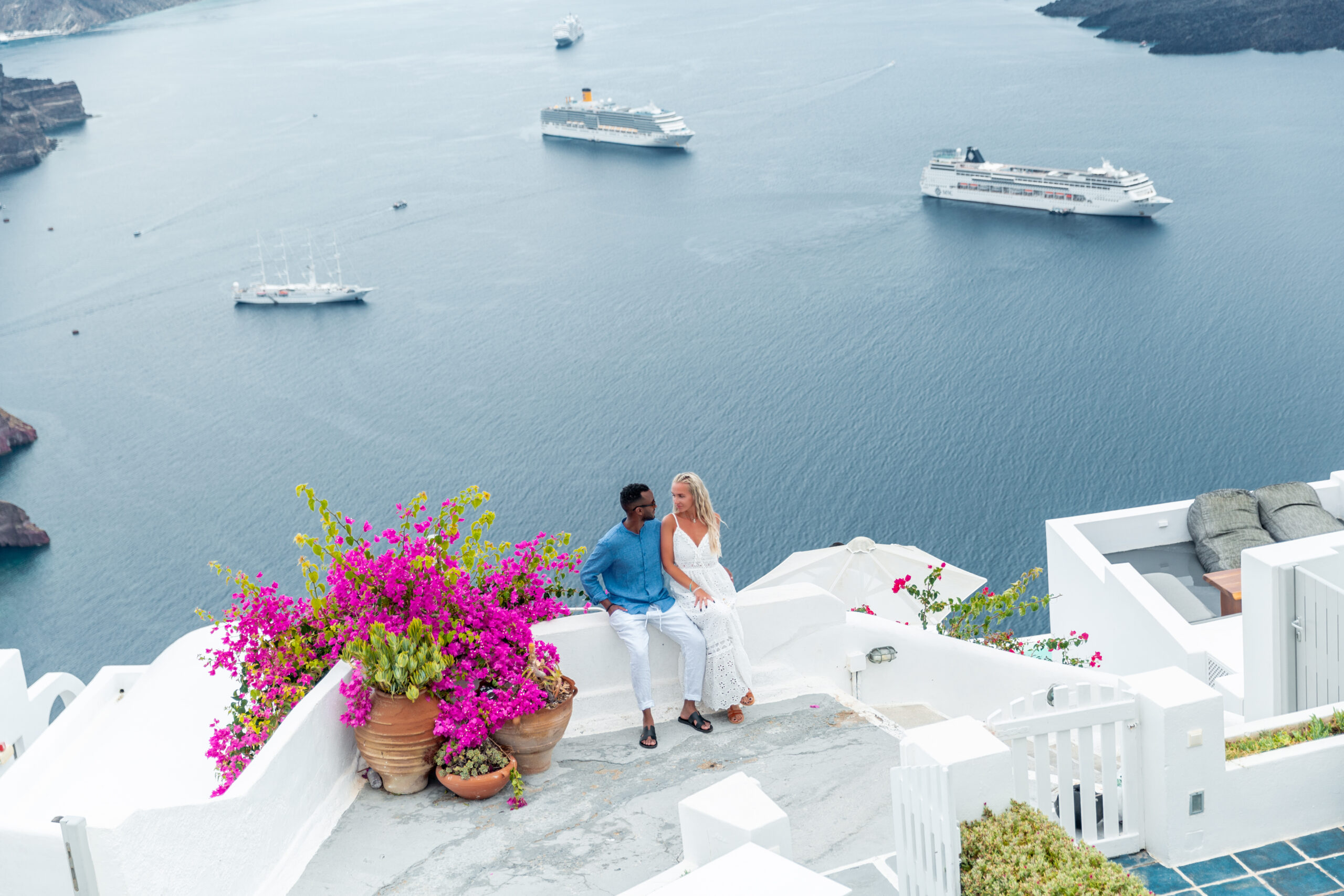 Santorini love story photoshoot. Santorini Photographer. Santorini. Santorini Photoshoot. Flying Dress Photoshoot in Santorini. Santorini Photography. Proposal Santorini