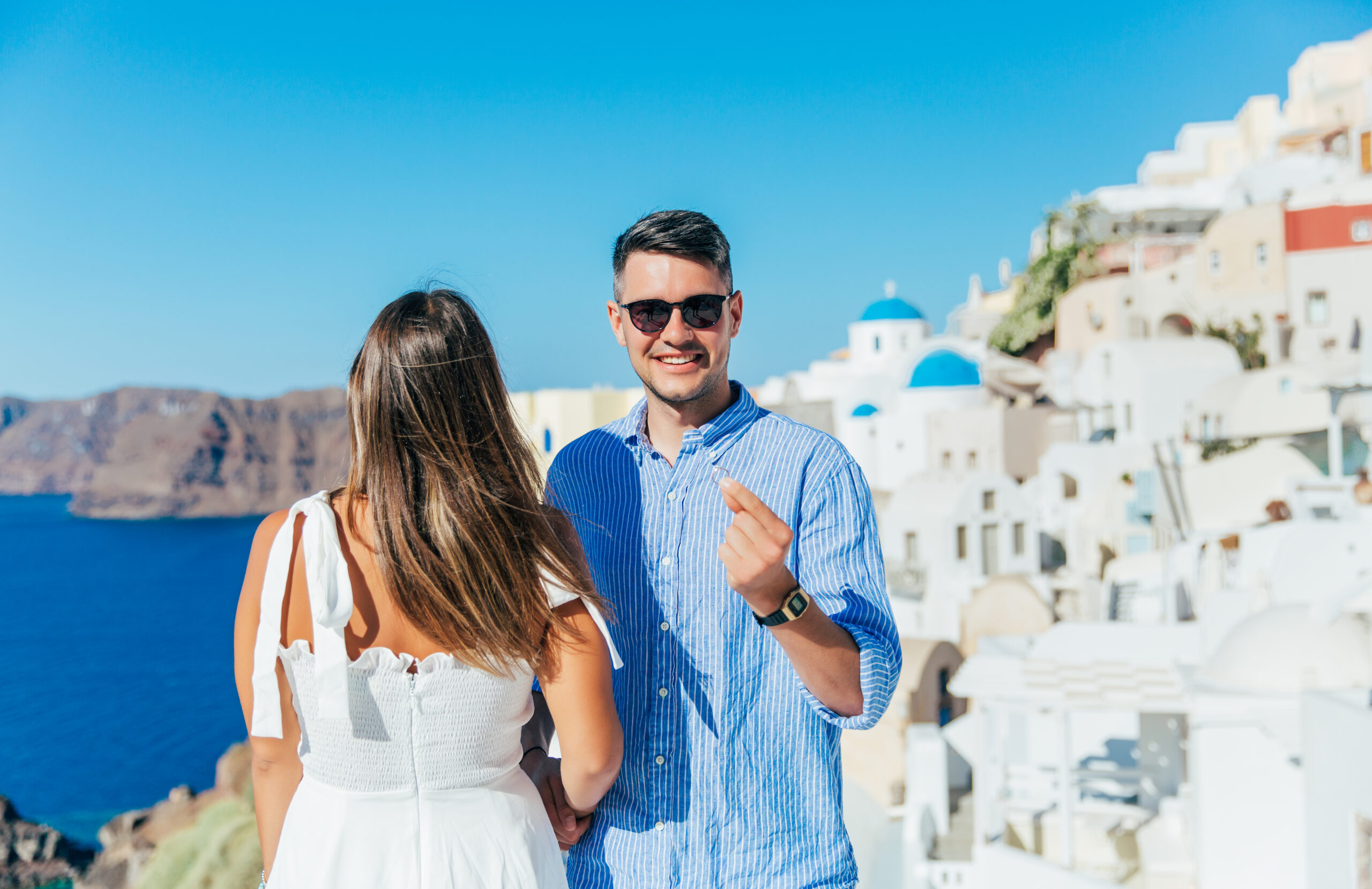 Proposal Santorini. Santorini love story photoshoot. Santorini Photographer. Santorini. Santorini Photoshoot. Flying Dress Photoshoot in Santorini. Santorini Photography.