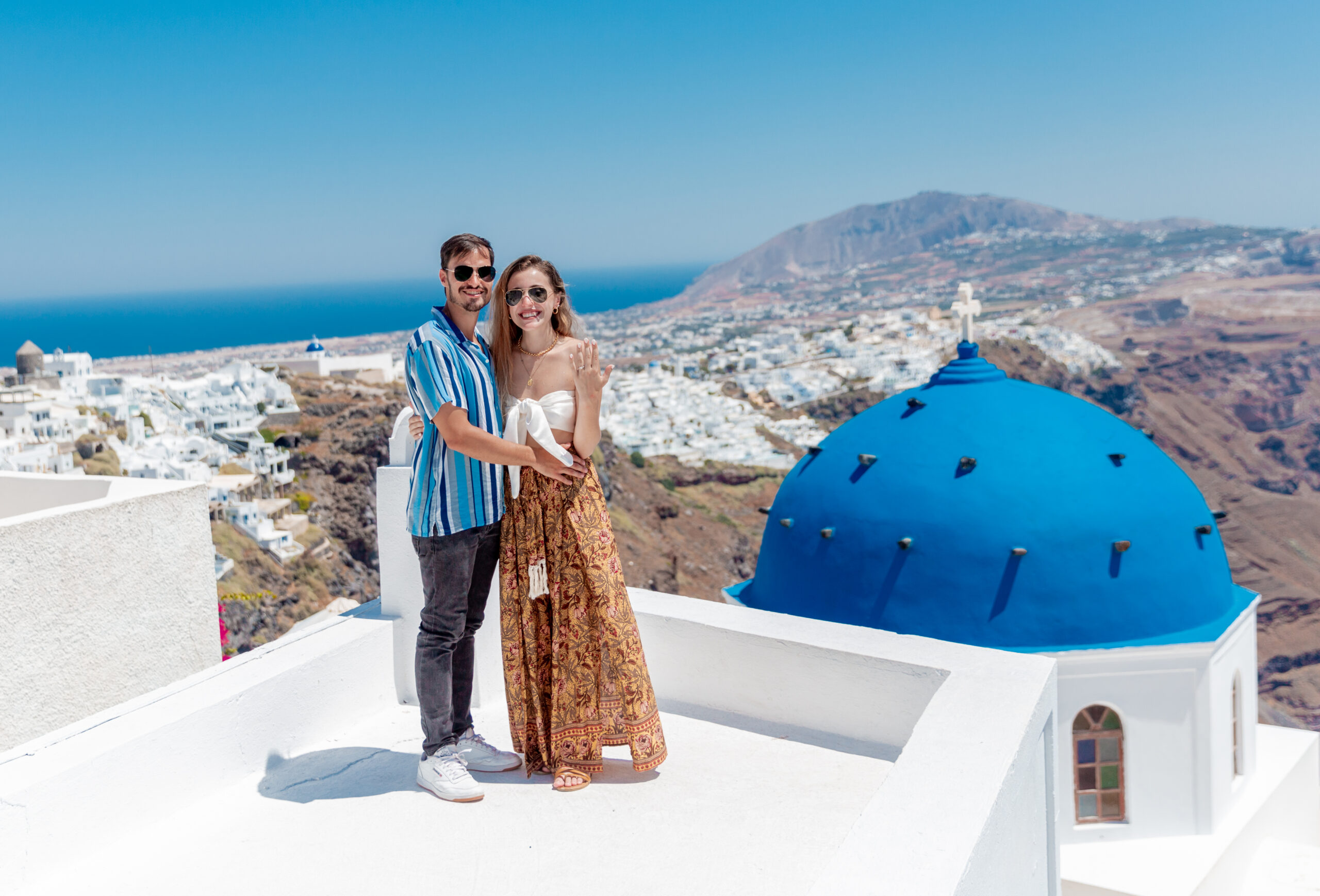 Proposal Santorini. Santorini love story photoshoot. Santorini Photographer. Santorini. Santorini Photoshoot. Flying Dress Photoshoot in Santorini. Santorini Photography.