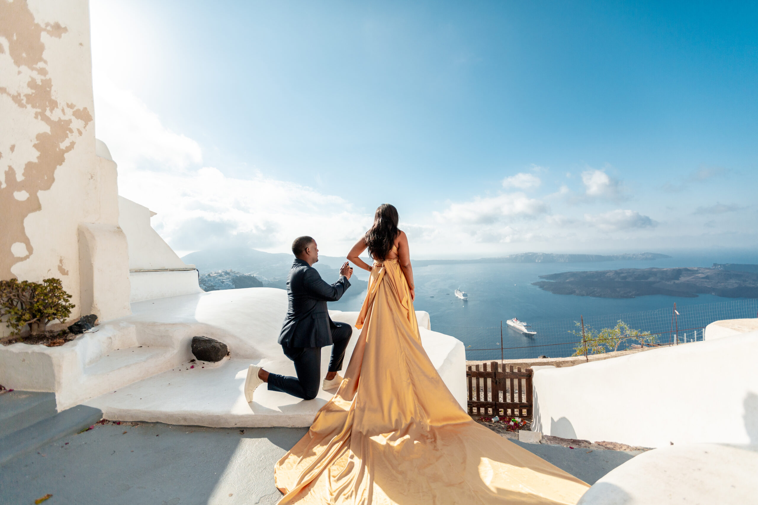 Proposal Santorini. Santorini love story photoshoot. Santorini Photographer. Santorini. Santorini Photoshoot. Flying Dress Photoshoot in Santorini. Santorini Photography.