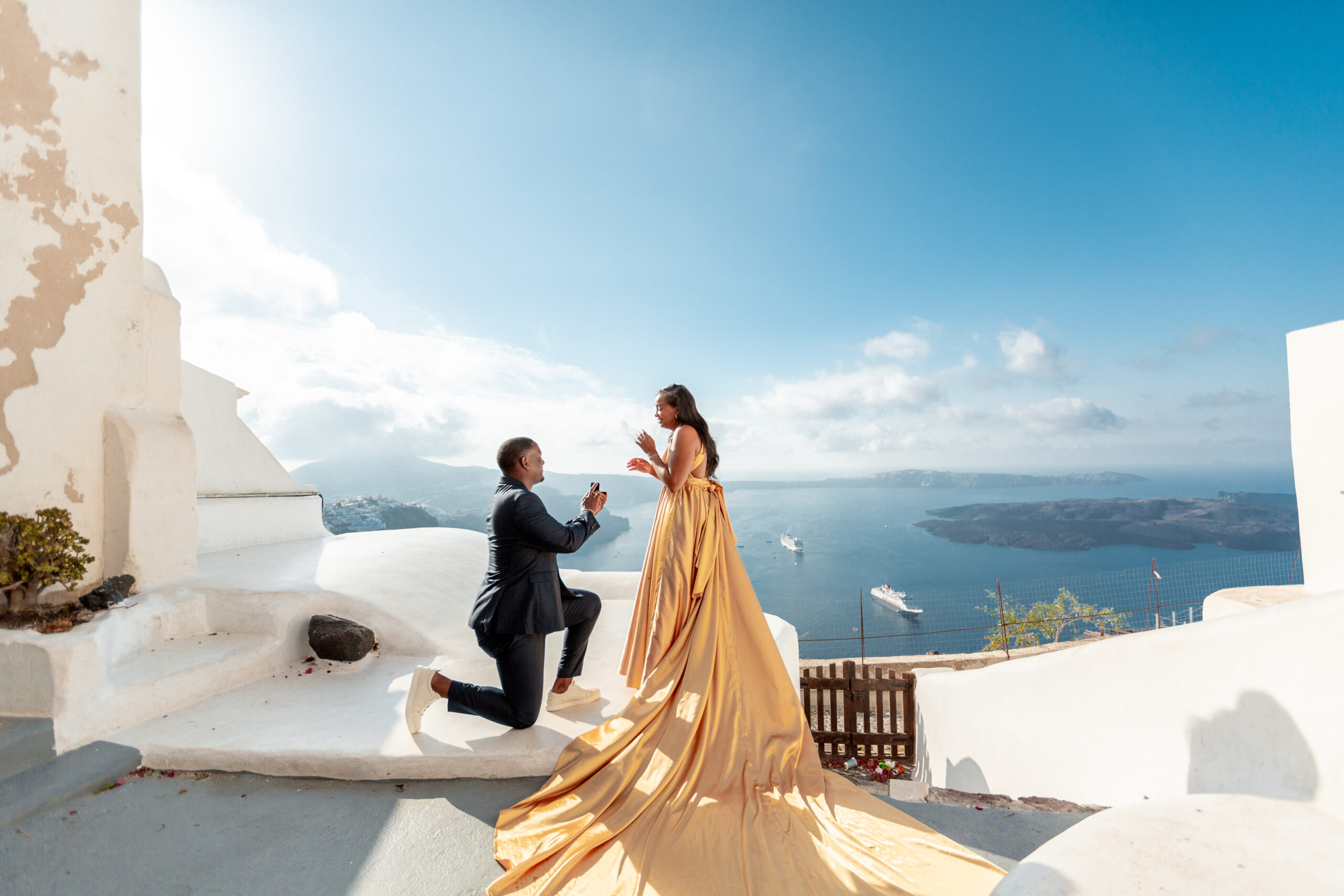 Proposal Santorini. Santorini love story photoshoot. Santorini Photographer. Santorini. Santorini Photoshoot. Flying Dress Photoshoot in Santorini. Santorini Photography.