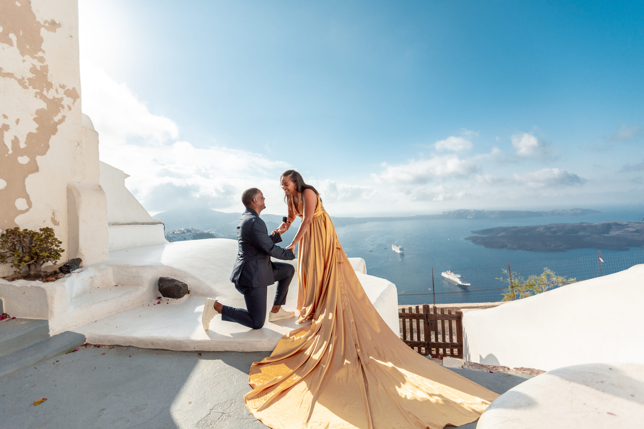 Proposal Santorini. Santorini love story photoshoot. Santorini Photographer. Santorini. Santorini Photoshoot. Flying Dress Photoshoot in Santorini. Santorini Photography.